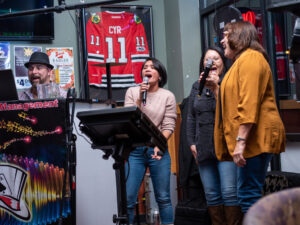 aces sip and sing karaoke with three women singing